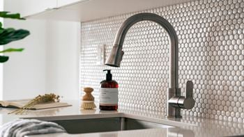 Modern kitchen sink with penny tile backsplash